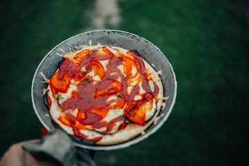 rustic pizza with tomatoes and ketchup on the nature outside  