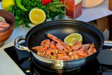 shrimp in a cauldron on the stove to prepare