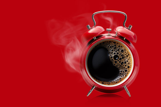 Red alarm clock with hot black coffee.