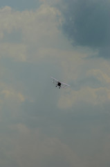 old light aircraft against the sky with clouds