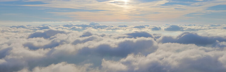 A sea of clouds. Blue sky with clouds in light colors. Web template, design background. Aerial...
