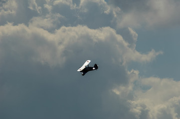 old light aircraft against the sky with clouds