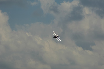 old light aircraft against the sky with clouds