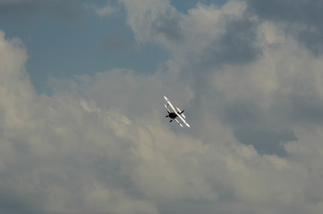 Fototapeta na wymiar old light aircraft against the sky with clouds