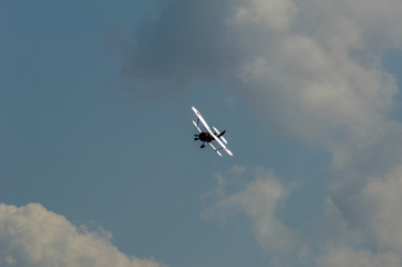 old light aircraft against the sky with clouds