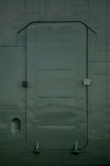 helicopter door painted in protective color with riveting