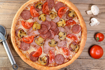 pizza with salami and mushrooms top view