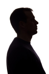 Portrait of a young man, side view - dark isolated silhouette
