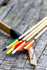 Bow and arrow next to each other.