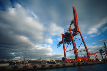 Logistics and transportation of Container Cargo ship with working crane bridge in shipyard at...