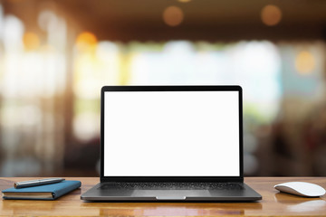 laptop computer blank white screen and pen on table in cafe background