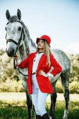 Obraz premium Beautiful young girl with blond hair in a suede jacket with a fringe , wearing black floppy hat