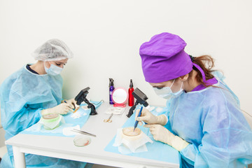 The doctor under the microscope recalculates the hair follicles. Baldness treatment. Hair...
