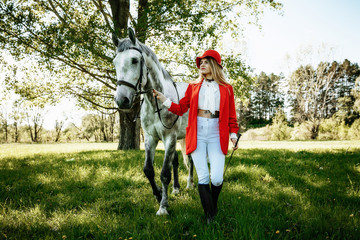 Beautiful young girl with blond hair in a suede jacket with a fringe , wearing black floppy hat