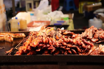 Close up of kebab sticks on a food stall in night market