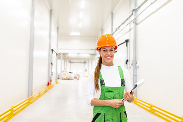 Portrait of a smiling female food factory warehouse worker.