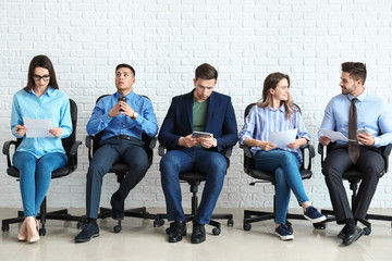 Fototapeta premium Young people waiting for job interview indoors