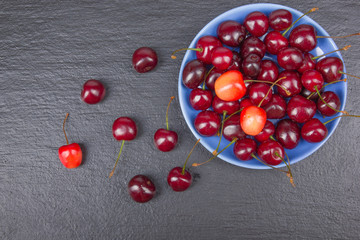 Various summer Fresh Cherry in a bowl on rustic wooden table. Antioxidants, detox diet, organic fruits. Berries