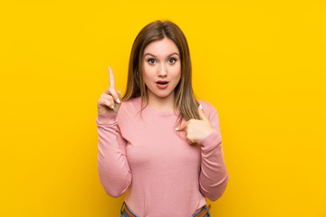 Teenager girl over isolated yellow background with surprise facial expression