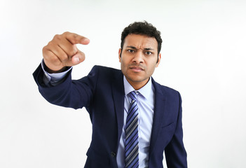 Handsome businessman pointing at viewer on white background