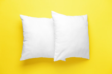 Soft pillows on color background