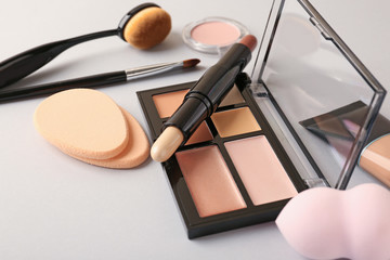 Set of cosmetics for contouring makeup on white background