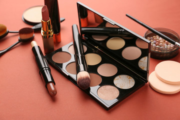 Set of cosmetics for contouring makeup on color background