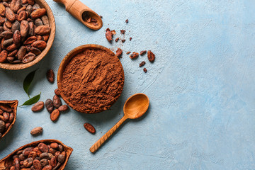 Composition with cocoa powder and beans on color background