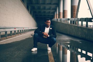 Black guy in a dark suit in a dark room