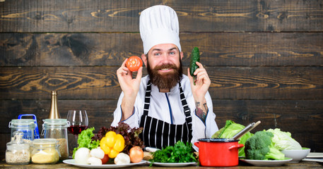 Summer taste. Vitamin. man use kitchenware. Professional chef in cook uniform. Dieting with organic food. Fresh vegetables. Happy bearded man cooking in kitchen. Healthy food and vegetarian