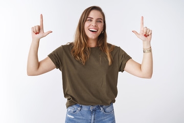 Happy good-looking charismatic young caucasian female tomboy model wearing olive t-shirt jeans...