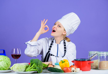 Girl adorable chef teach culinary. Best culinary recipes to try at home. Amazing taste. Turn ingredients into delicious meal. Culinary skills. Woman chef wear hat apron near table ingredients