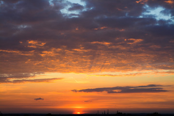 Obraz premium Beautiful summer sunset on the background of the plant pipes away