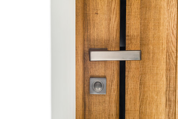 modern style door handle on natural wooden door