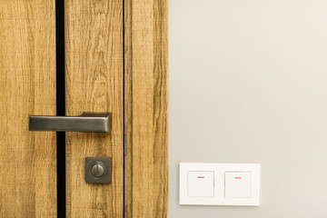 modern style door handle on natural wooden door