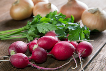 radish onion and parsley vegetables on a rustic table