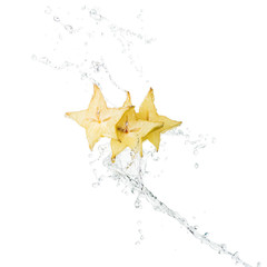 fresh exotic star fruit slices and water splash with drops isolated on white