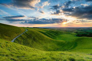 Dramatic sunset sky over The Manger at Uffington