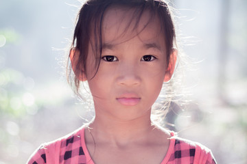 Close up portrait Asian cute little girl. children look at camera at thailand