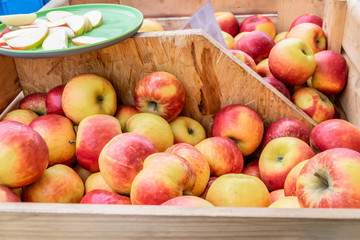 Apples in a box at the farmers market. Autumn harvest from the orchard. Harvest in the grocery market.