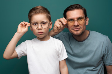 Shot of handsome father and son wearing stylish eyeglasses