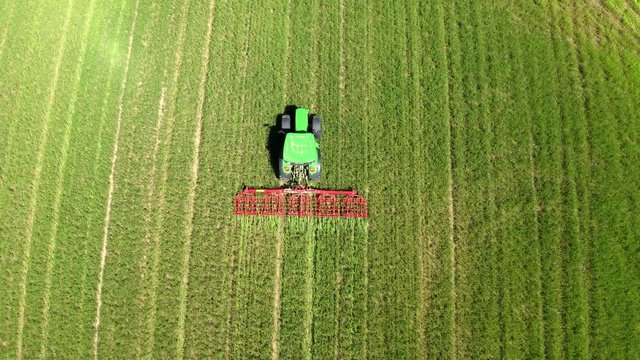 Aerial view, tractor drives over a field and loosens the ground, Usingen, Schwalbach, Hochtaunuskreis, Hesse, Germany