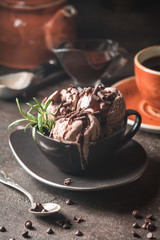 Chocolate coffee ice cream balls in a bowl over dark background