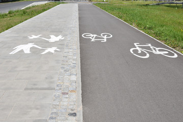 Pavement with two marked lanes: for pedestrians and for bicycles, closeup perspective view. - 269998465