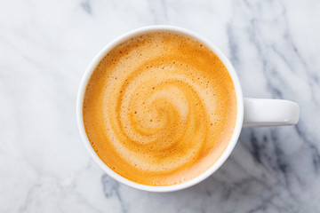 Coffee, espresso in white cup of marble table background. Top view.
