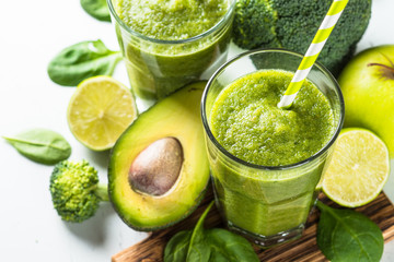 Green smoothie from fruit and vegetable on white.