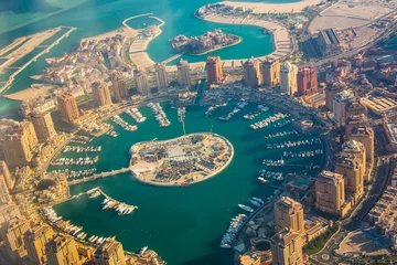Fotobehang Rich real estate Pearl-Qatar island in Doha through the airplane porthole, aerial view © yurich84