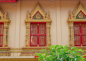 Wealthy window in golden and red colors in thai temple