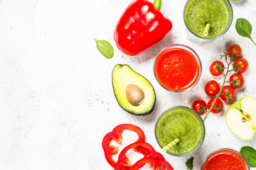 Red and Green vegetable smoothie on white.