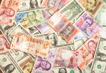 Fototapeta na wymiar Background made of dollar, Thai baht, Qatari riyal, hryvnia banknotes